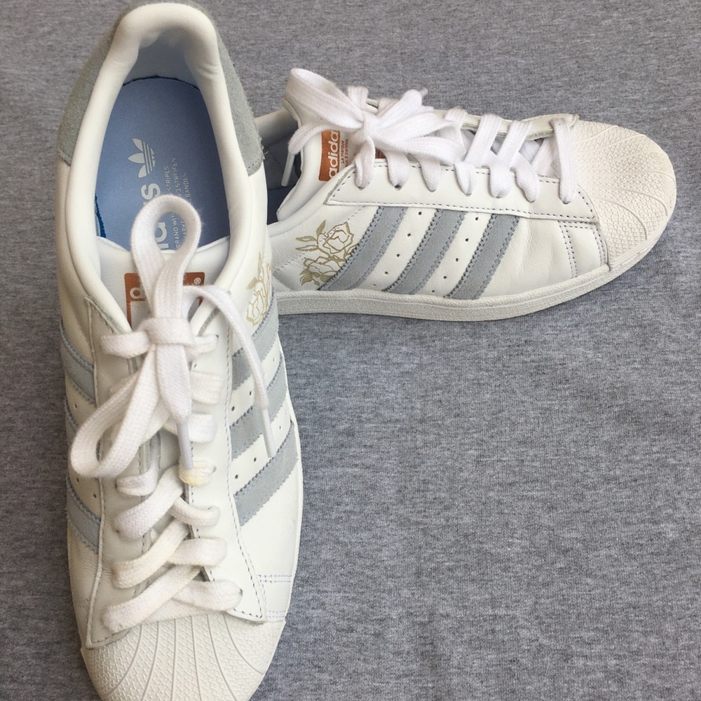 Adidas blue and gold flower superstars